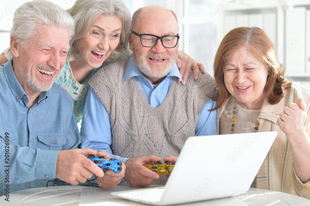 Senior couples reading newspaper Senior couples reading newspaper