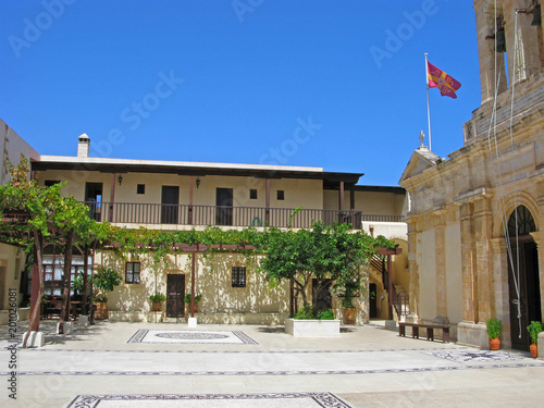 Greece, Crete. Courtyard of Monastery of Panagia Odigitria with vineyard. Floor of yard is decorated of pattern of cobblestone in traditional style hoklaquia. Monastery is located 26 km from Chania.