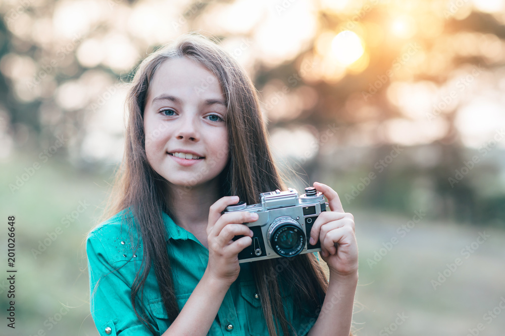 Portrait of a pretty little brunette girl smiling and holding a Portrait of a pretty little brunette girl smiling and holding a