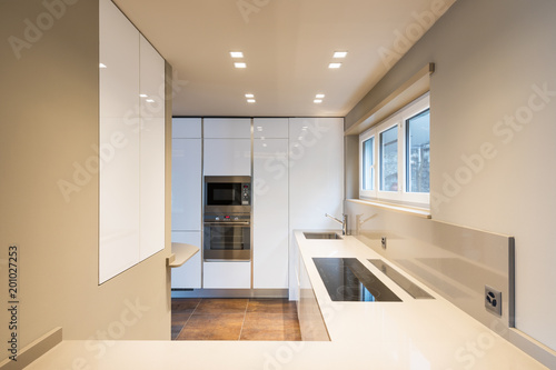 Kitchen with modern white furniture and latest generation appliances