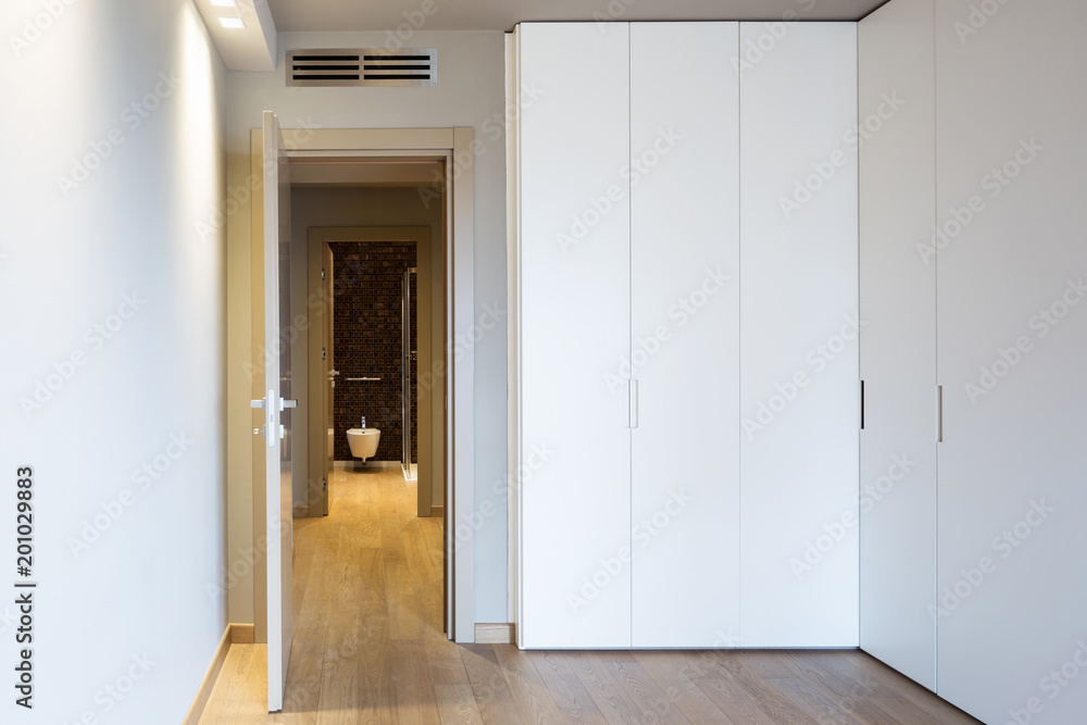 Front view of modern room with large wardrobe Front view of modern room with large wardrobe