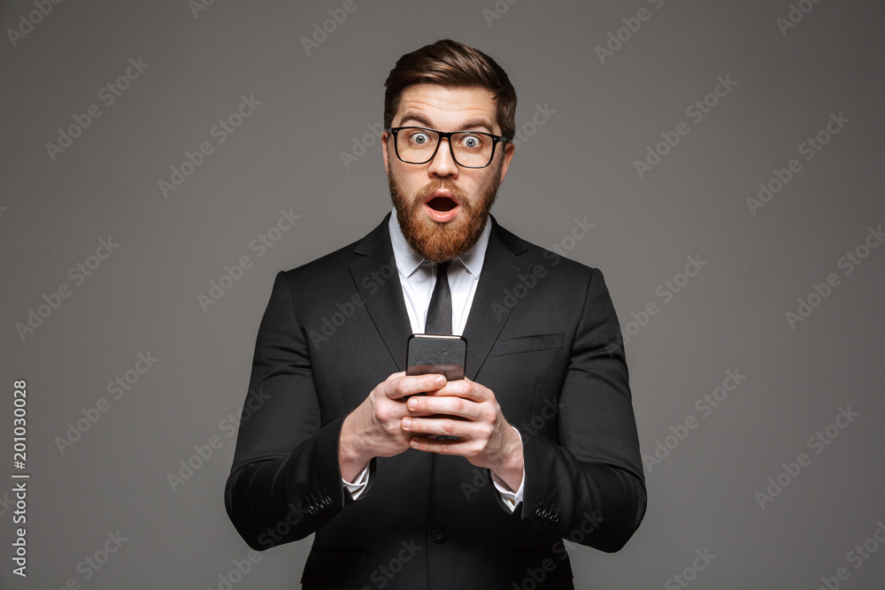 Portrait of an excited young businessman dressed in suit Portrait of an excited young businessman dressed in suit