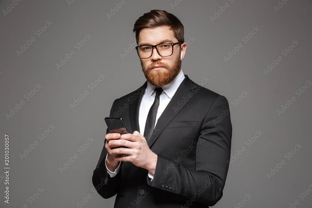 Portrait of a serious young businessman in earphones Portrait of a serious young businessman in earphones