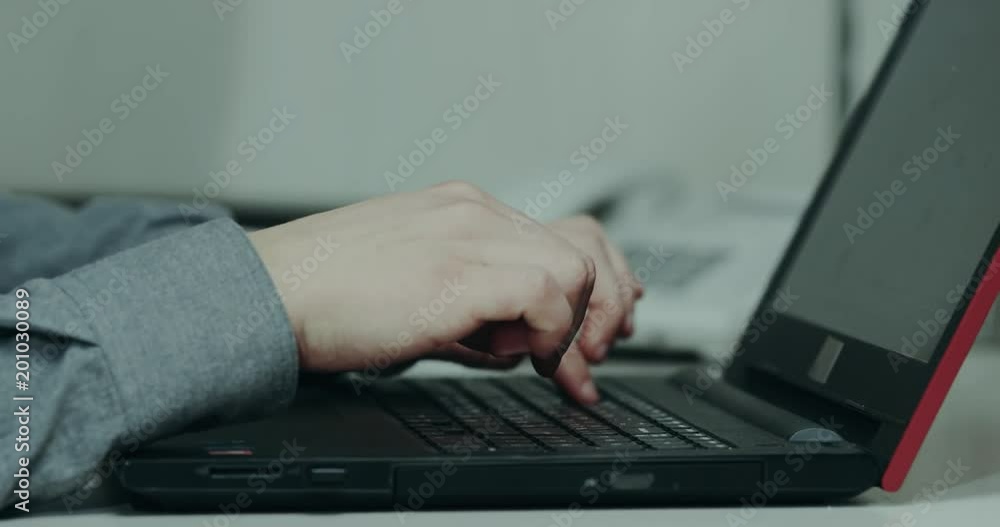 Closeup office desk men tapping on his keyboard from the laptop Closeup office desk men tapping on his keyboard from the laptop