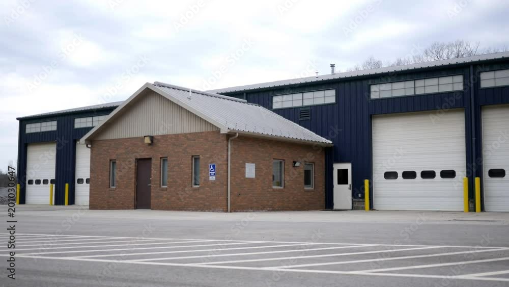 Establishing shot of Blue warehouse building on overcast day Establishing shot of Blue warehouse building on overcast day