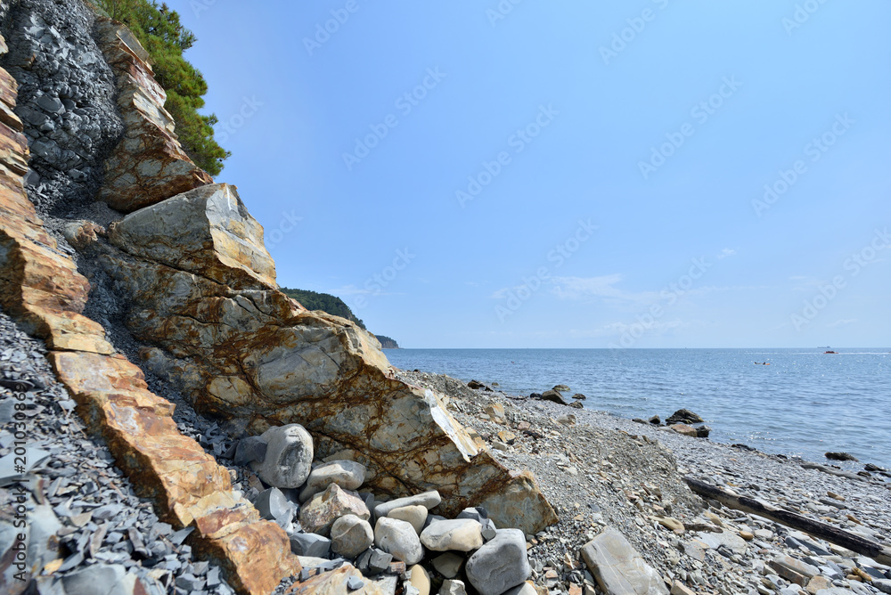 A beautiful rocky shore with sharp edges overlooking the sea A beautiful rocky shore with sharp edges overlooking the sea