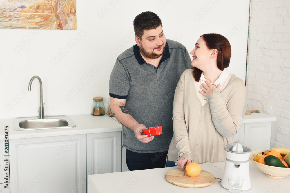 size plus boyfriend gifting present to girlfriend at kitchen size plus boyfriend gifting present to girlfriend at kitchen