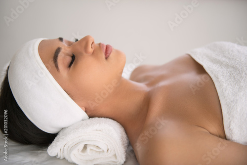 Pleasurable rest. Pleasant attractive woman being in the spa along while trying to relax