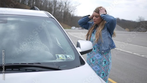 Woman cannot get into her car and is locked out photo