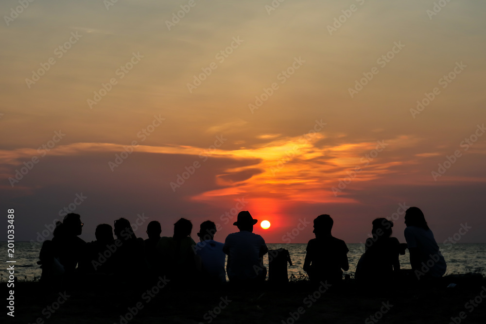 silhouette all people in family meeting look sunset sky on beach