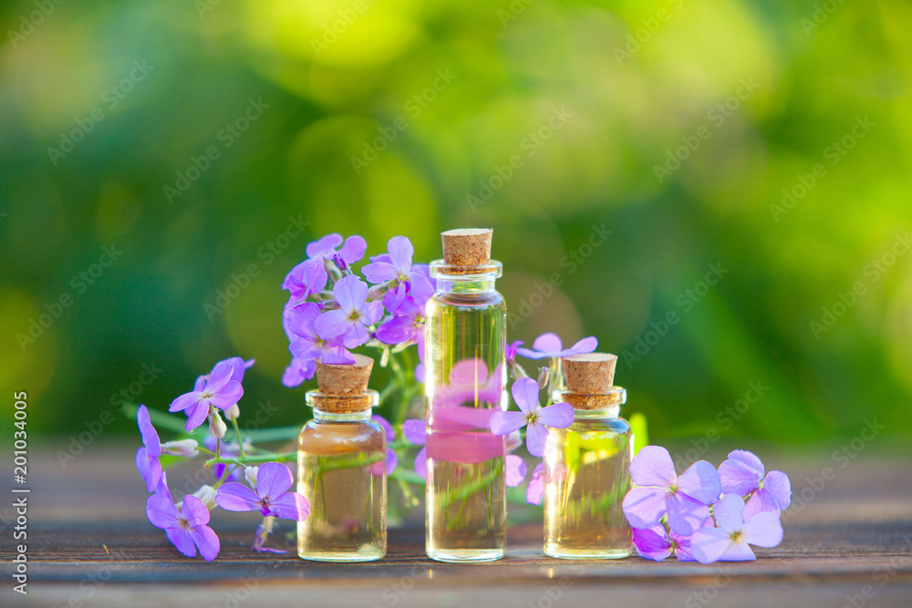 Essence of flowers on table in beautiful glass jar Essence of flowers on table in beautiful glass jar
