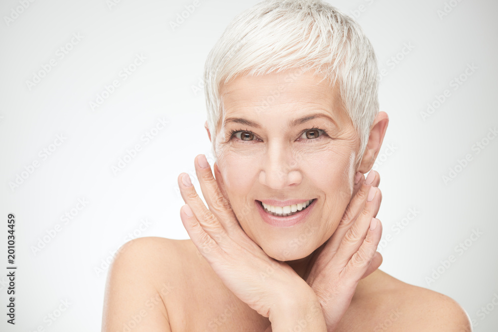 Fototapeta premium Portrait of beautiful senior woman in front of white background.