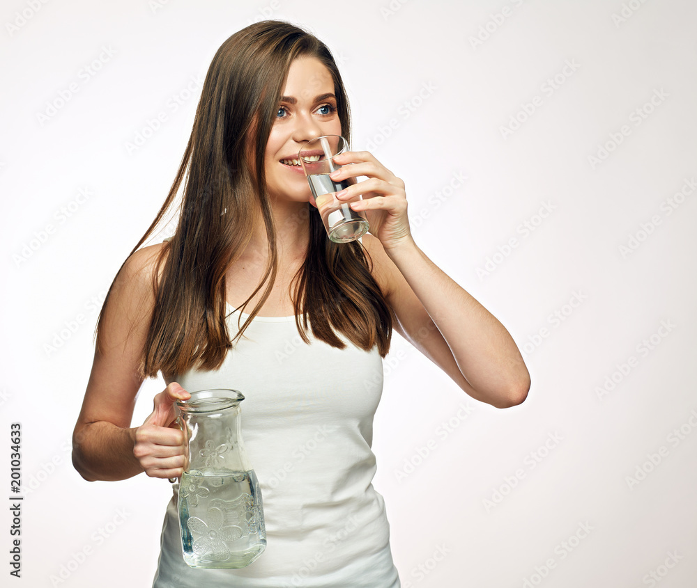 Woman drinking water holding glass dekanter. Woman drinking water holding glass dekanter.