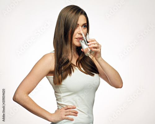 Young woman drinking water from glass.