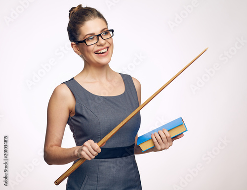 Smiling woman teacher holding book and wooden pointer. photo