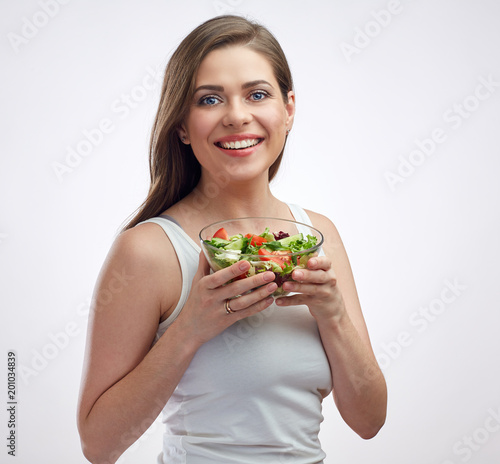 isolated portrait of smiling woman holding vegetable salad.
