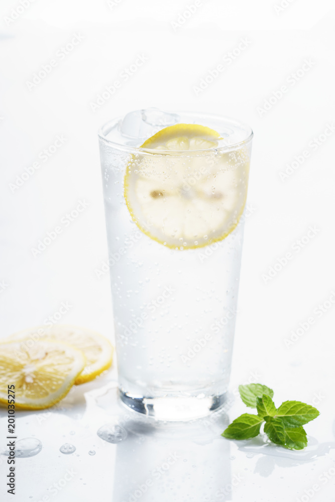 glass of lemon sparkling water. glass of lemon sparkling water.