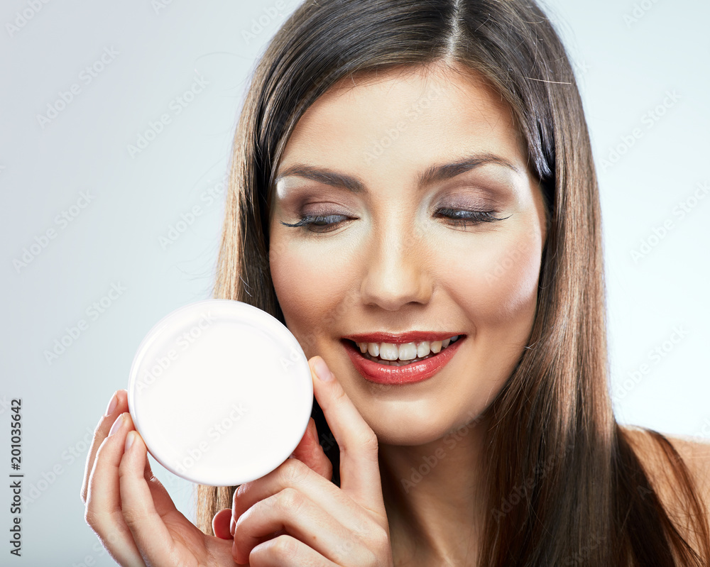 Beauty portrait of smiling girl holding skin cream. Beauty portrait of smiling girl holding skin cream.