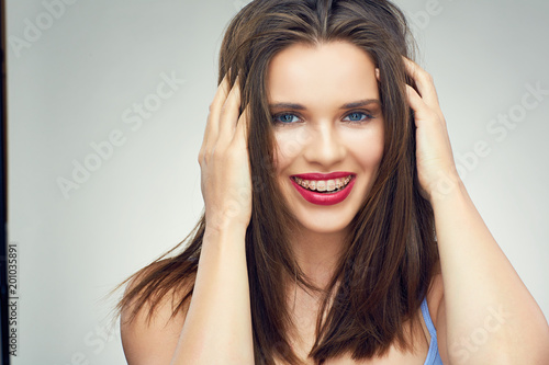 Face portrait of smiling teenager girl with dental braces.