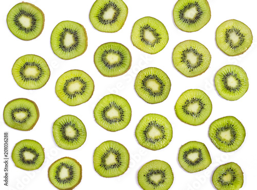 Colorful fruit pattern of fresh green slices of kiwi isolated on white background, top view