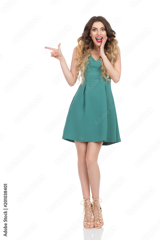 Fototapeta premium Surprised Elegant Woman Is Holding Hand On Chin And Pointing