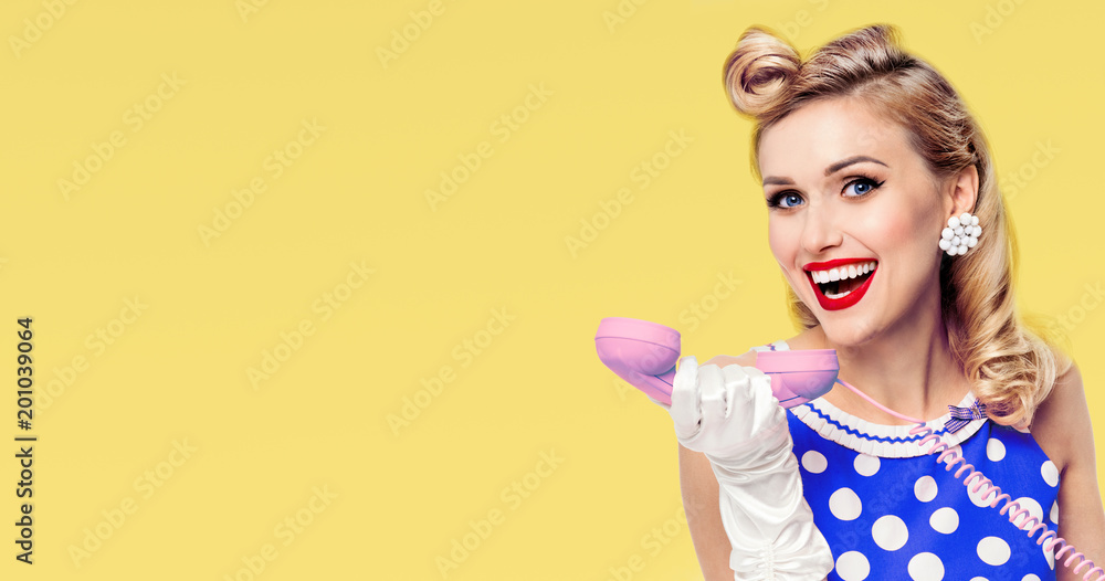 smiling woman with phone, dressed in pin-up style dress