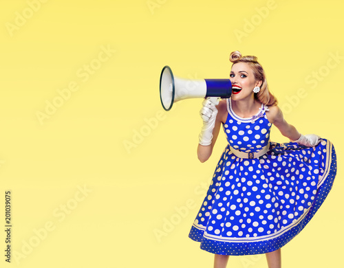 happy woman holding megaphone, dressed in pin-up style dress