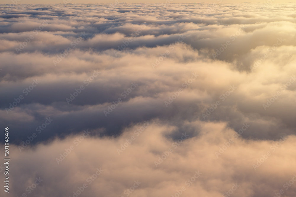 over clouds, view from above, sunlight, clouds close, flight by airplane