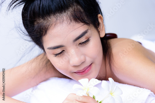 Portrait of beautiful asian people with close up view and close up eyes and smelling a flower. Beauty  healthy  spa and relaxation concept.