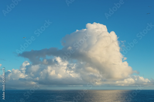 Blue sky with clouds over sea at sunset. Nature composition.