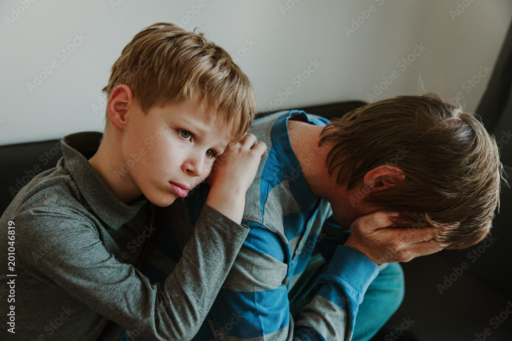 sad child with stressed father, family in sorrow sad child with stressed father, family in sorrow