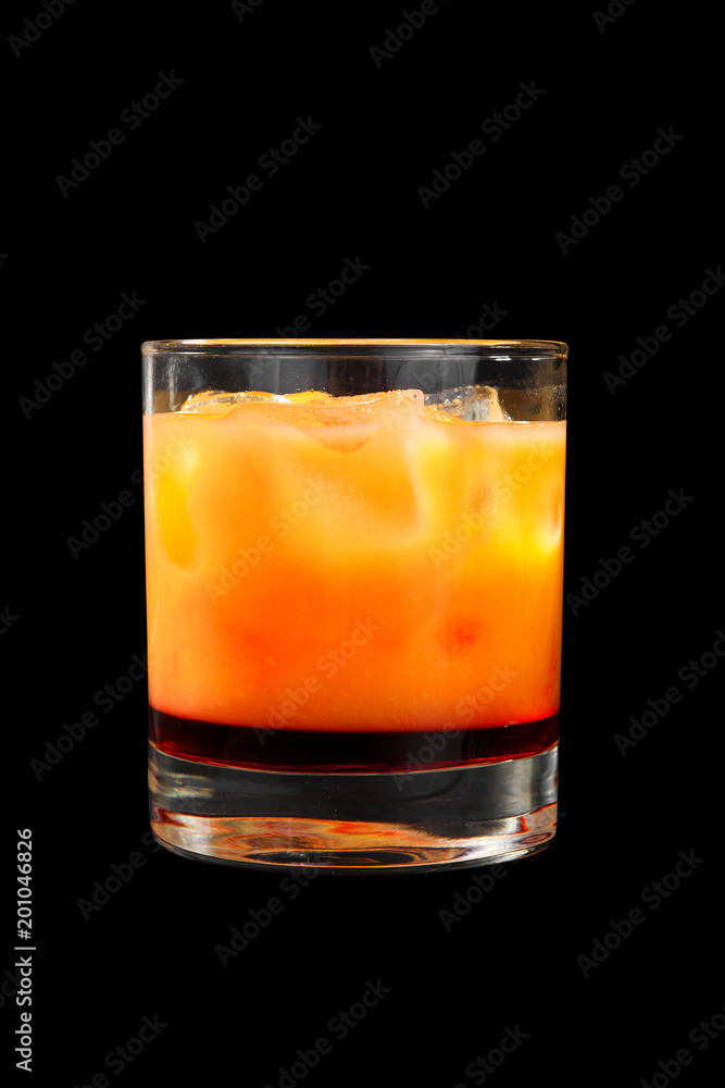 Multi-colored two-layer opaque cocktail in a low glass with ice cubes with melon, pear, apple, berries, fruit, pineapple, orange, apricot, peach. Side view Isolated black background Drink for the menu Multi-colored two-layer opaque cocktail in a low glass with ice cubes with melon, pear, apple, berries, fruit, pineapple, orange, apricot, peach. Side view Isolated black background Drink for the menu