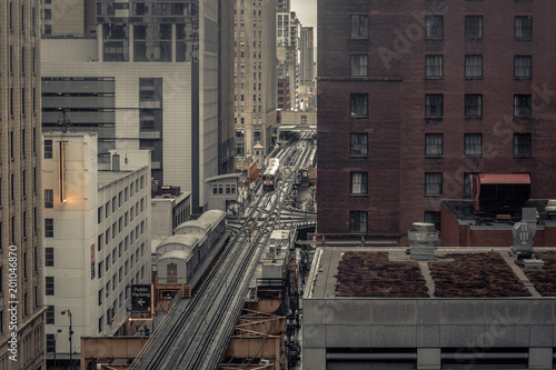 Elevated subway tracks cutting through the middle of an urban area