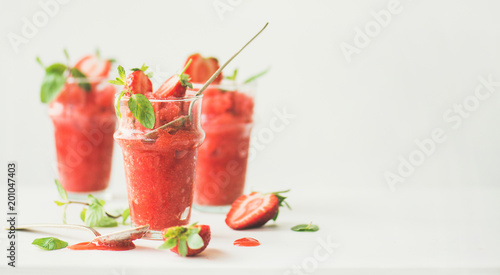 Healthy low calorie summer treat. Strawberry and champaigne granita, slushie or shaved ice dessert in glasses, white background, copy space, wide composition. Clean eating, vegan, dieting food concept