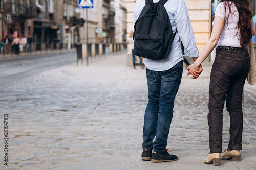 Cropped image of middle-aged couple holding hands on the street