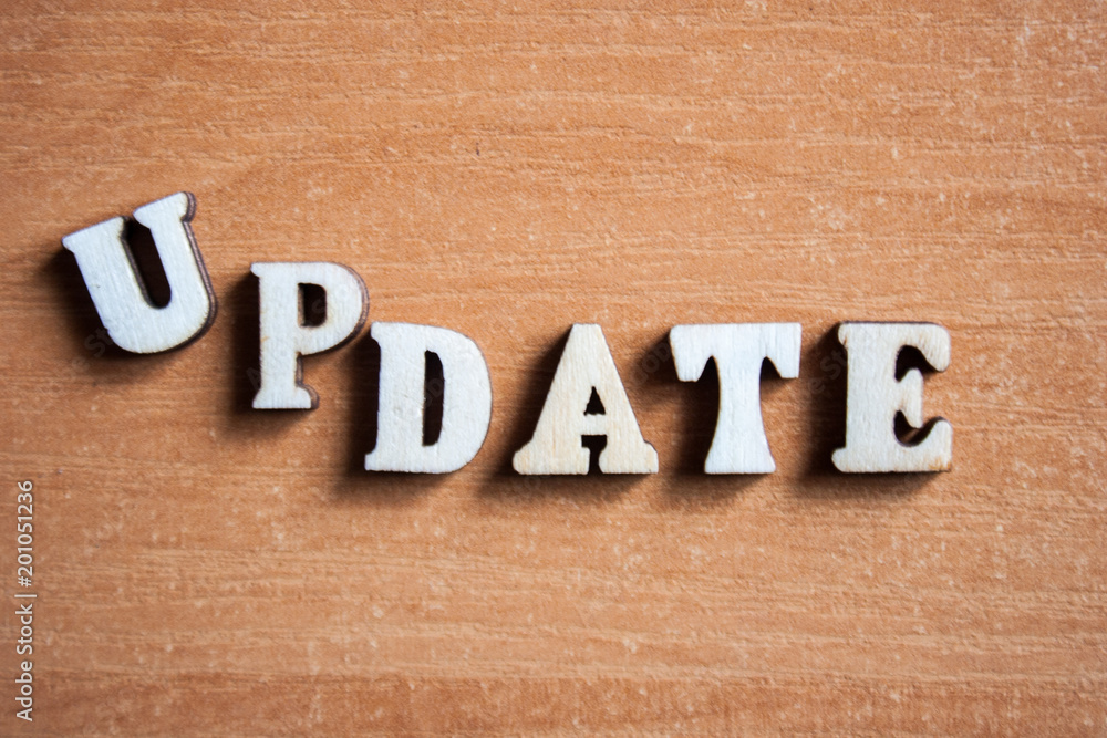 The word 'update' made of wooden letters. wood inscription The word 'update' made of wooden letters. wood inscription