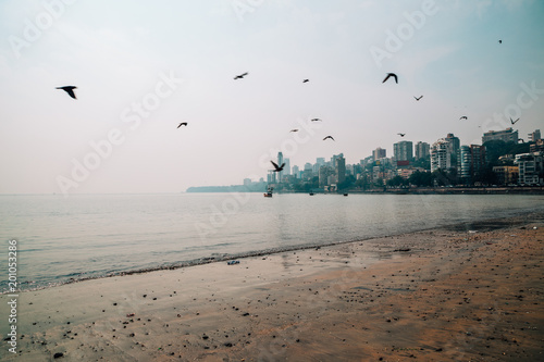 Girgaon Chowpatty beach and modern buildings in Mumbai, India photo