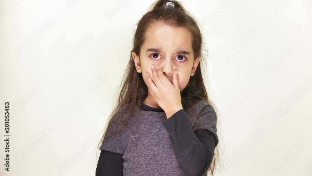Little beautiful sad girl shows an emotion of resentment, anger, looks at the camera, portrait, white background 50 fps Little beautiful sad girl shows an emotion of resentment, anger, looks at the camera, portrait, white background 50 fps