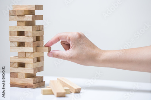 Business risk concept with wood jenga game.