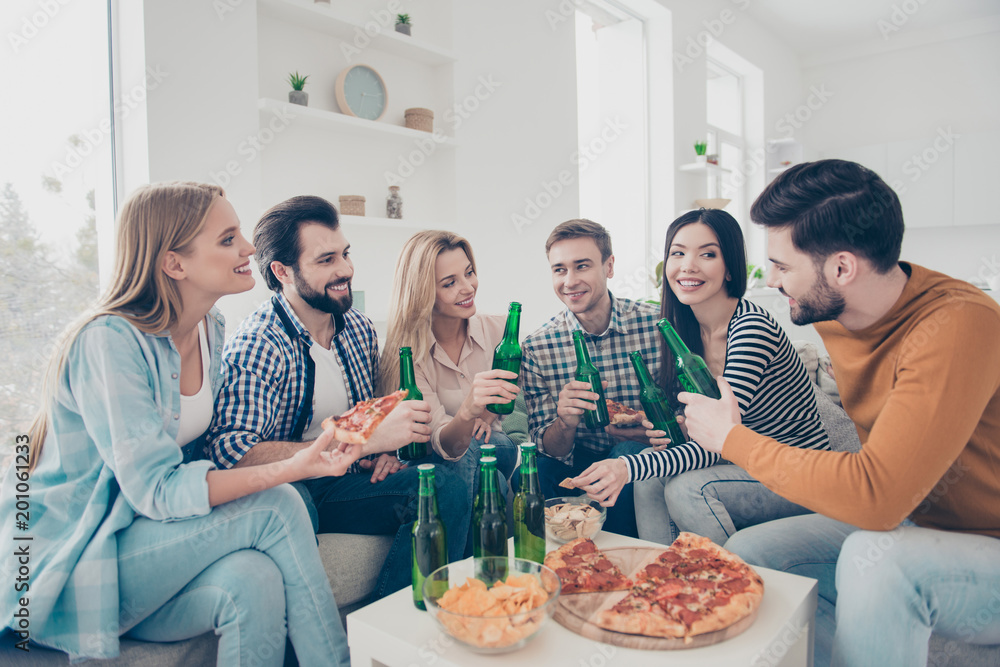 Cheerful, stylish, attractive, positive community sitting in livingroom, house having snacks on the table speaking talking spending free time together enjoying weekend Cheerful, stylish, attractive, positive community sitting in livingroom, house having snacks on the table speaking talking spending free time together enjoying weekend