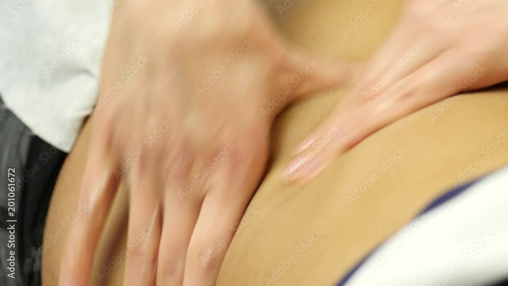 female doctor does a abdominal massage to patient. cosmetic procedures in clinic. 4K female doctor does a abdominal massage to patient. cosmetic procedures in clinic. 4K