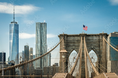  Brooklyn Bridge and one world trade center New York, Manhattan with US flag and airplane at blue sky. panorama photo