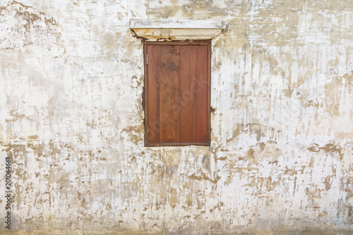 Old grunge wall with wooden window