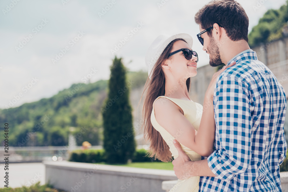 Portrait of romantic sweet attractive lovely trendy cute couple hugging face to face looking at each other over beautiful urban background enjoying meeting daydream time together