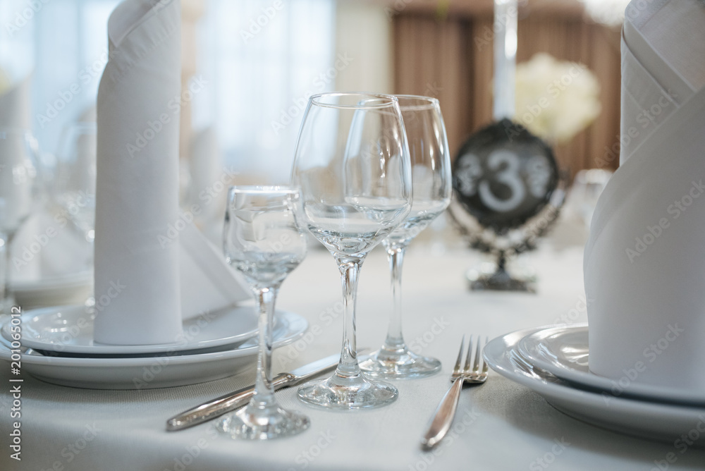 Served for dinner in restaurant with cozy interior. Wedding decorations and items for food, arranged by the catering service on a large table