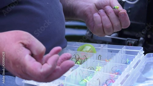 fisherman hands selecting his hook close up 4k photo