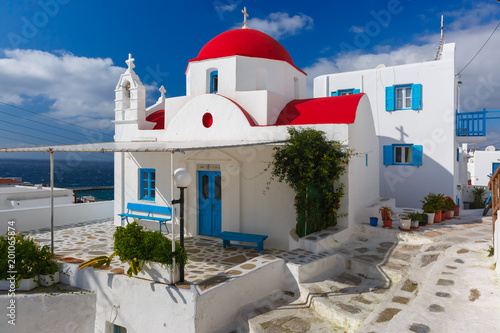 Traditional church with red dome and whitewashed facade, typical Greek church building on the island Mykonos, The island of the winds, Greece