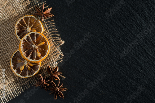 a composition of dried lemons and anise on natural slate © Alexander Gogolin