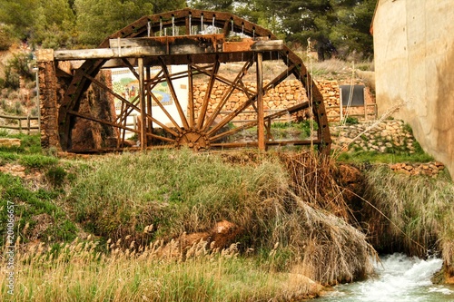 Old wooden waterwheel and Cabriel River on its way through Casas del Rio village, Albacete, Spain.