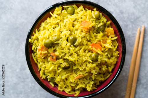 Yellow Saffron Basmati Rice with Turmeric  and Vegetables Pilav or Pilaf in Bowl with Chopsticks.